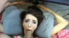 Play The 18-year-old brunette is lying on the bed and sucking his cock